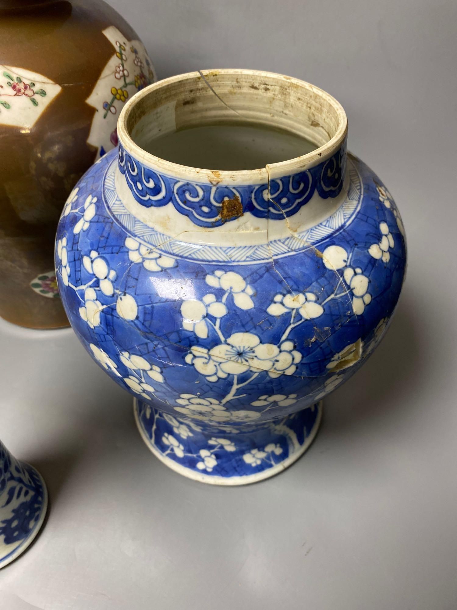 Two Chinese Kangxi period blue and white vases and a Qianlong Batavia vase and cover, largest 36cm high including the cover